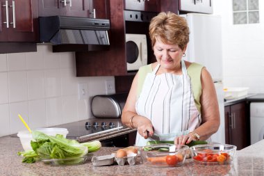 Elderly woman cooking clipart