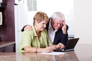 Senior couple worrying about money situation clipart