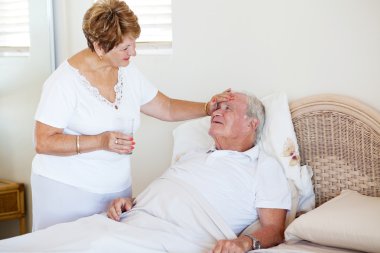 Senior wife comforting ill husband clipart