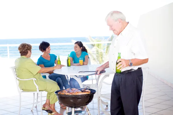 Grandpa doing barbeque for the family — Stock Photo, Image