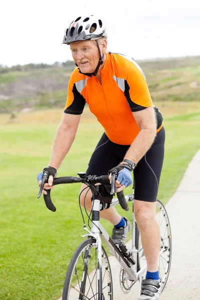 Senior man riding bicycle — Stock Photo, Image