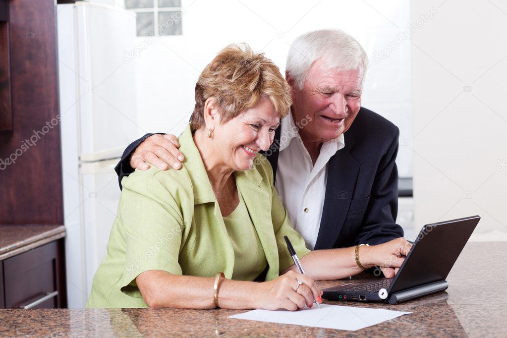 Happy senior couple checking bank balance