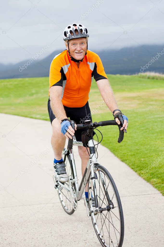 Active senior man riding bicycle