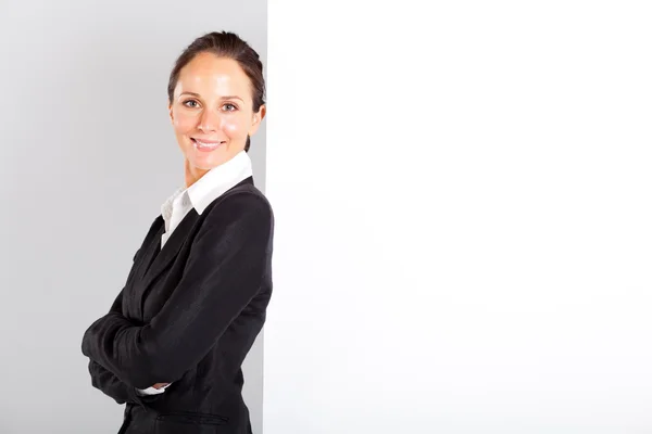 Businesswoman standing next to white board — Stock Photo, Image