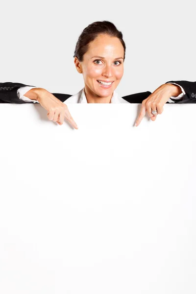 Businesswoman pointing at white board — Stock Photo, Image