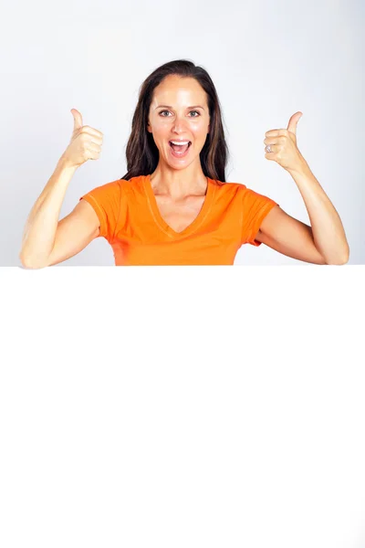 Cheerful woman thumbs up with white board — Stock Photo, Image
