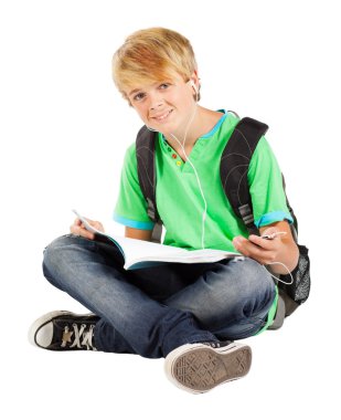 Teen boy sitting on floor reading book clipart