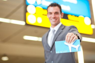 Young businessman presenting air ticket clipart