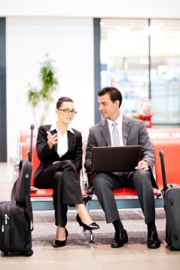 Business travellers waiting for flight at airport clipart