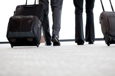 Business travellers walking in airport clipart