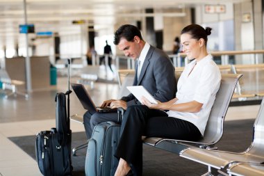 Business travellers waiting for flight clipart