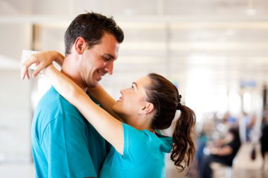 Young couple say good bye at airport clipart