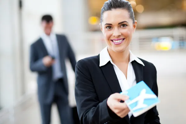 Businesswoman handing over air ticket — Stock Photo, Image