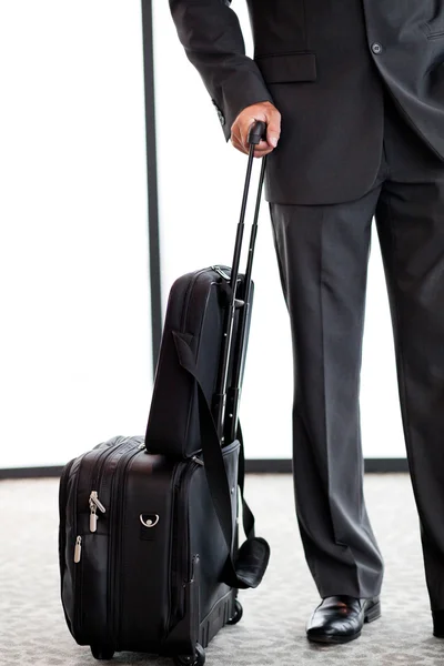 Businessman with luggage at airport — Stock Photo, Image