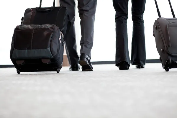 Viajantes a negócios caminhando no aeroporto — Fotografia de Stock