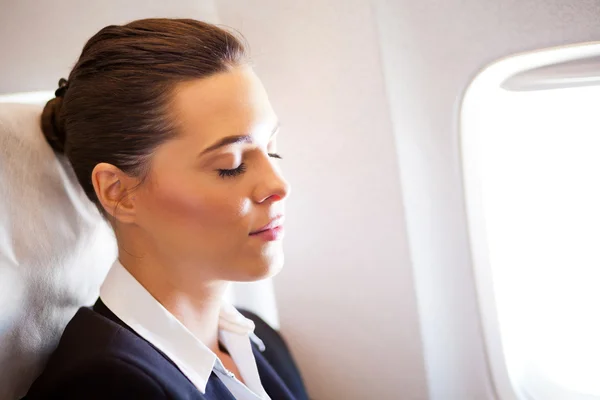 Businesswoman resting on airplane — Stock Photo, Image