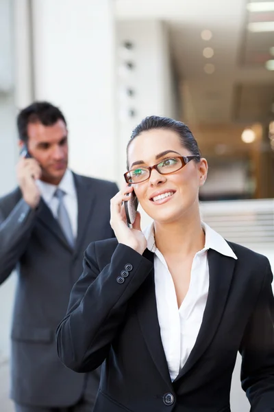 Businesspeople talking on mobile phone — Stock Photo, Image