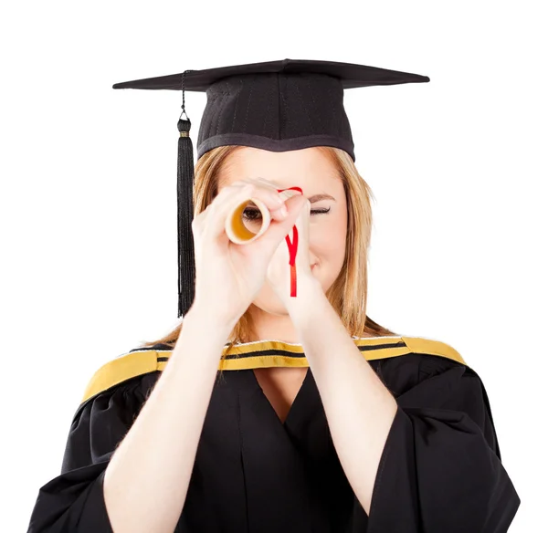 Female graduate looking through her certificate — Stock Photo, Image