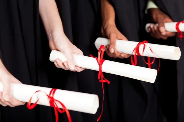 Graduates holding diploma — Stock Photo, Image