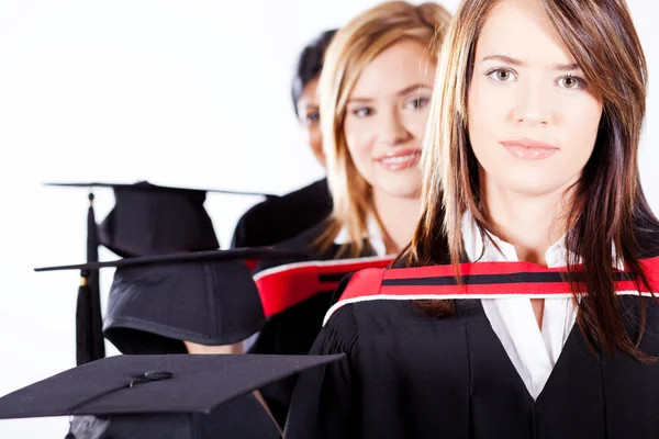 Graduates holding graduation caps — Stock Photo, Image