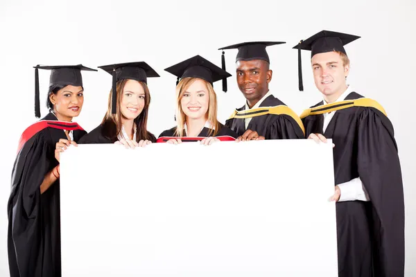 Group of graduates whit white board — Stock Photo, Image