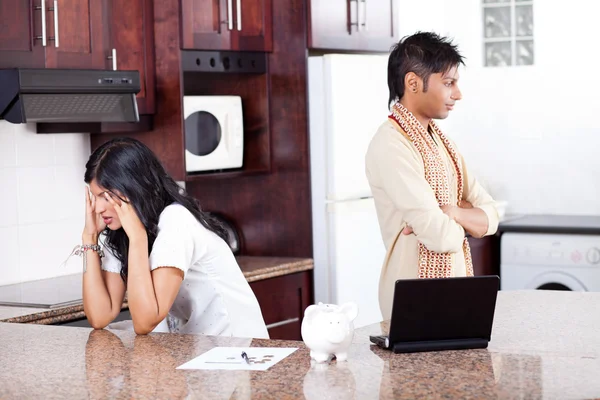 Young indian couple arguing on money in kitchen — Stock Photo, Image
