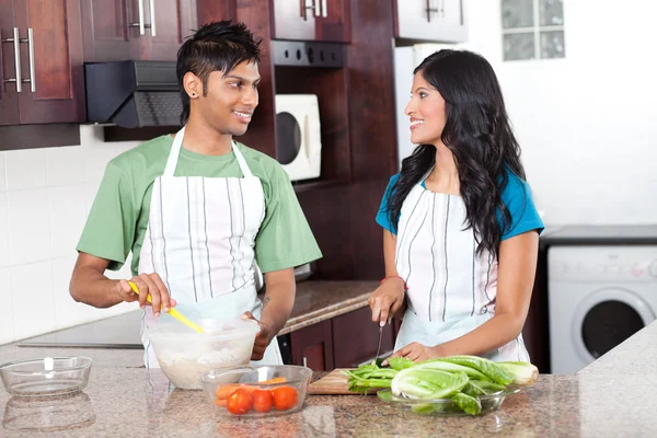 Modern indian couple cooking in kitchen — Stock Photo, Image