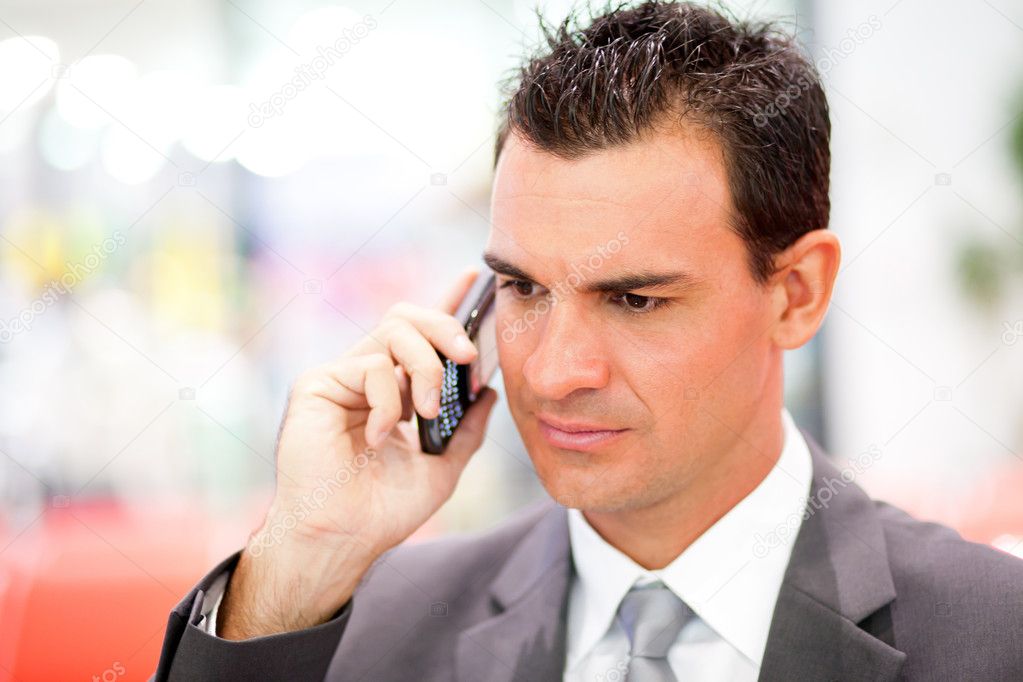 Serious businessman on cell phone
