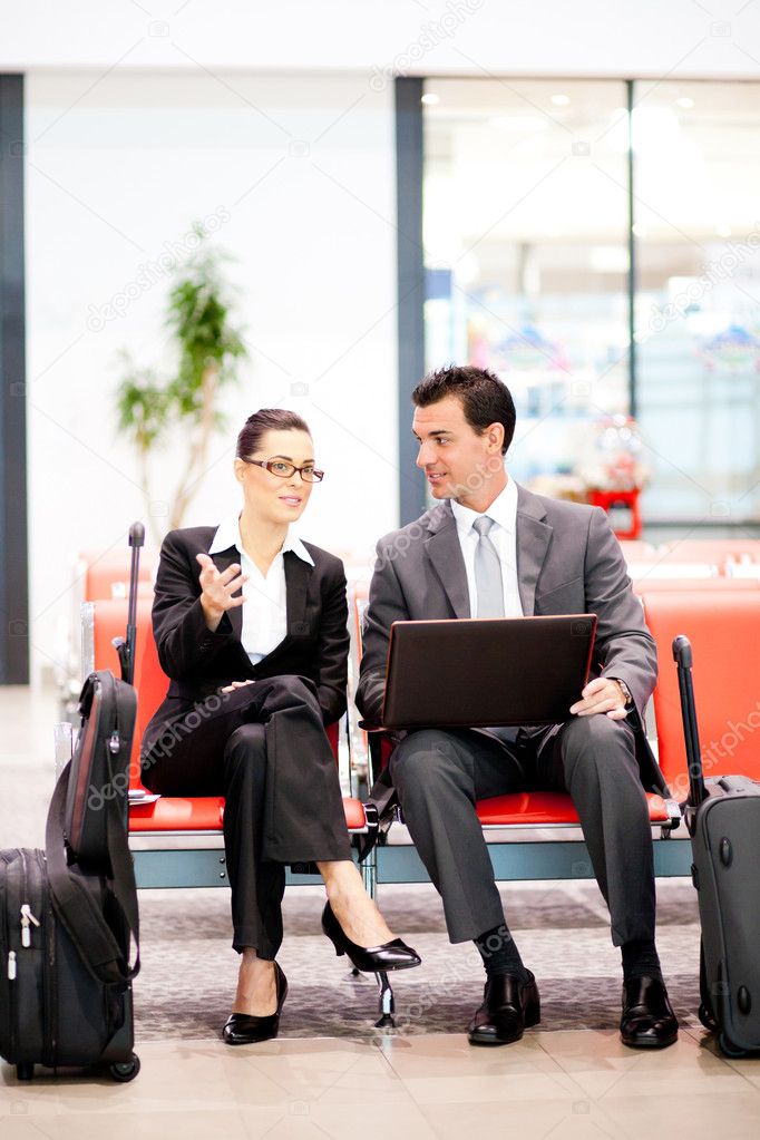 Business travellers waiting for flight at airport
