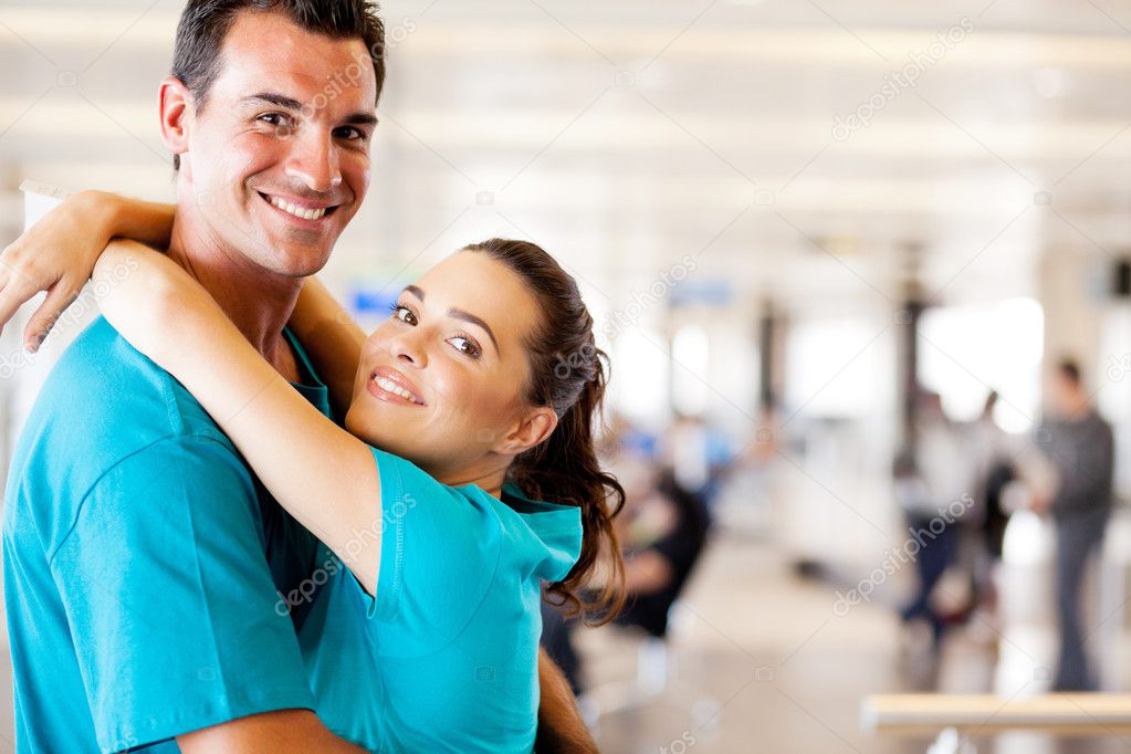 Happy young couple at airport