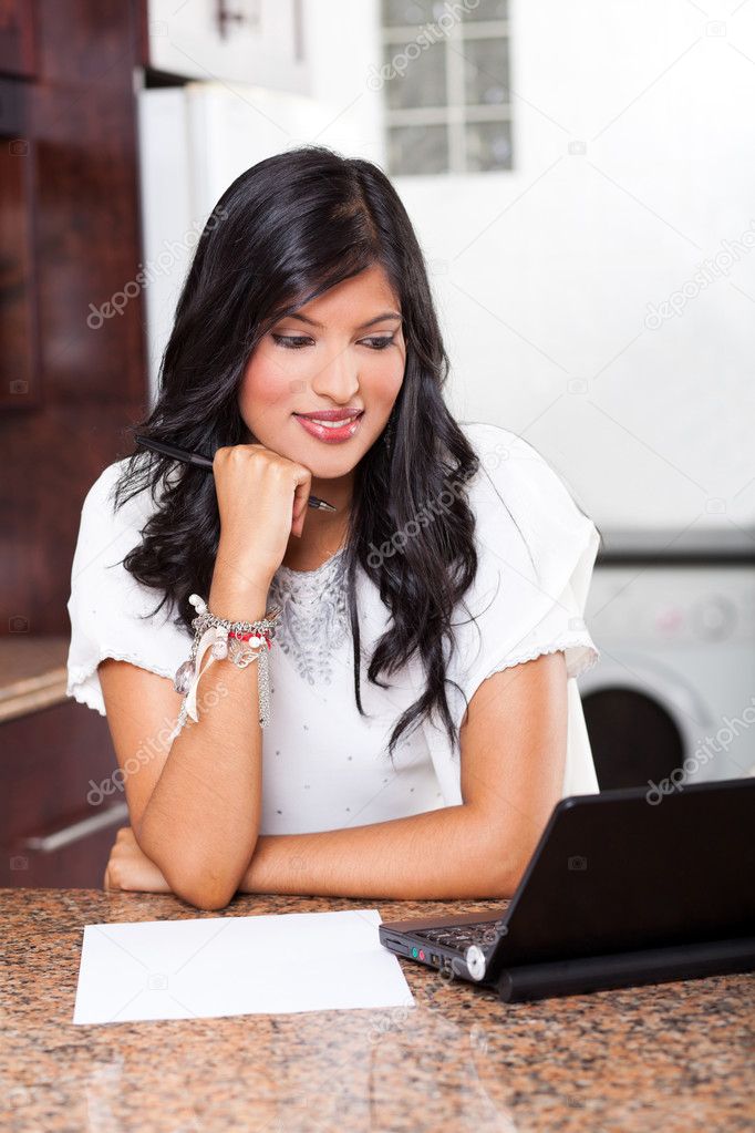 Indian woman using computer at home