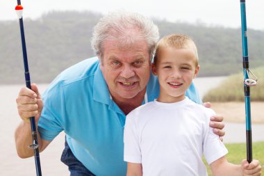 Grandfather and grandson fishing clipart