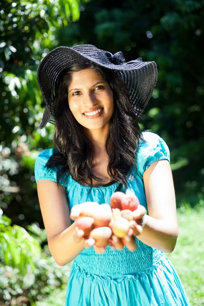 Woman holding litchis in both hands — Stock Photo, Image