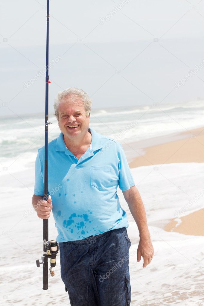 Senior man fishing on beach
