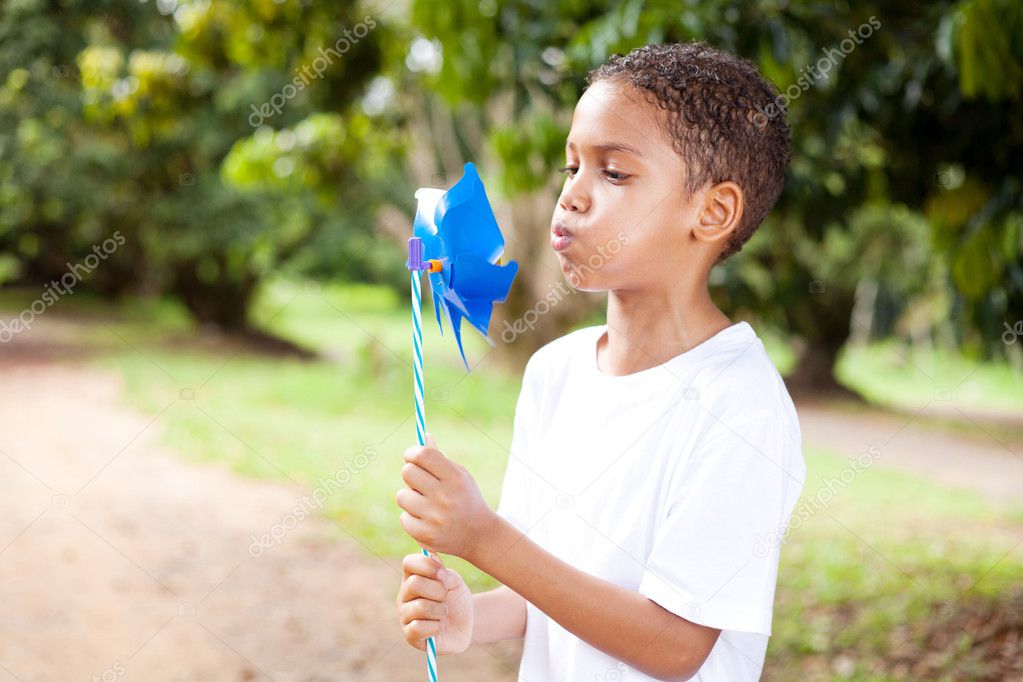 Little boy blowing on a pinwheel
