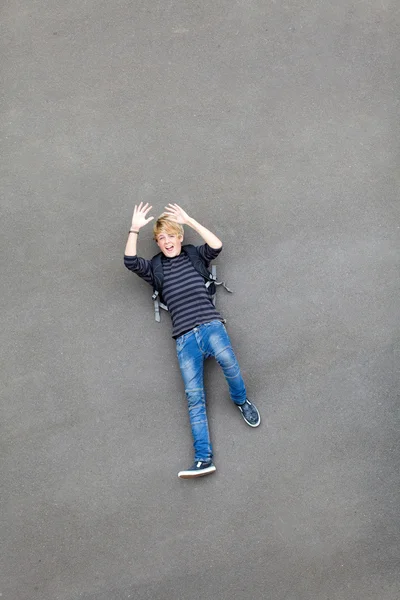 stock image Playful teen boy lying on ground