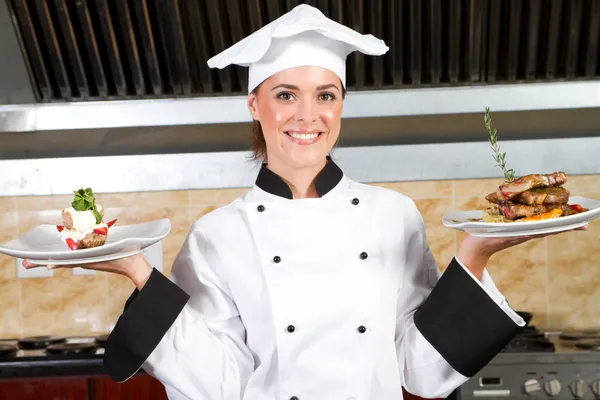Female chef holding food Stock Photo