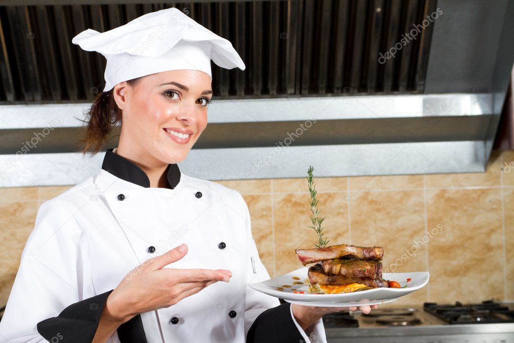 Young beautiful female chef presenting food — Stock Photo © michaeljung ...