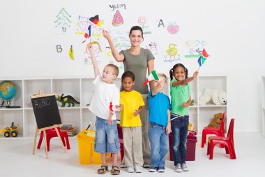 Reschool kids and teacher with flags in classroom clipart