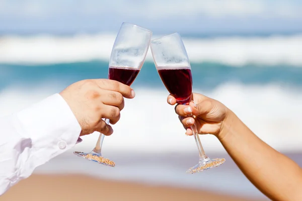 stock image Man and woman drinking champagne on beach