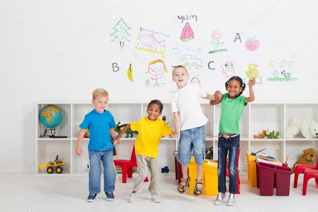 Group of cheerful preschool kids jumping up