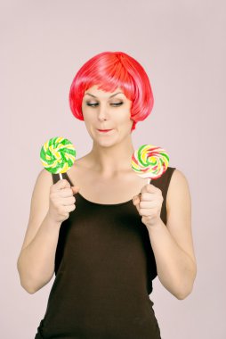 Beautiful girl can not choose what to eat candy clipart