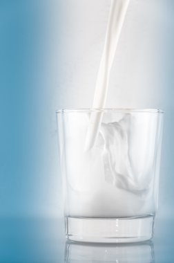 Pouring milk into a glass clipart