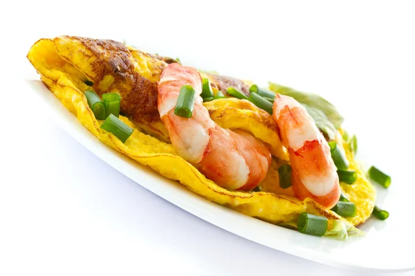 stock image Omelet with cooked shrimp and greens