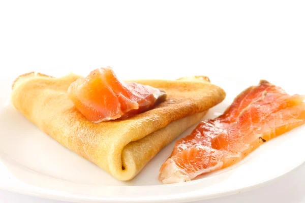 Pancakes with salted red fish — Stock Photo, Image