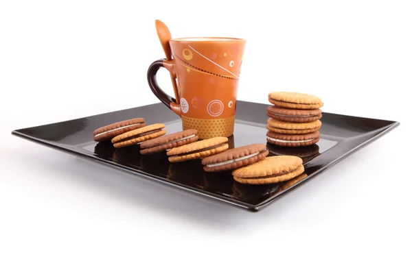 stock image Cup of tea with biscuits on black Dish, breakfast