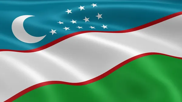 Uzbecká vlajka ve větru — Stock fotografie