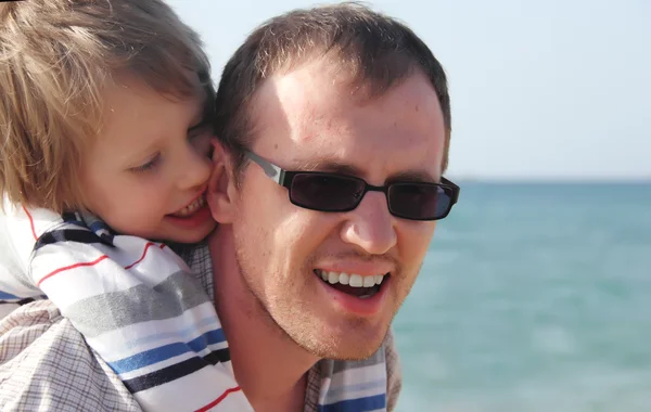 Gelukkig vader en zoon op het strand — Stockfoto