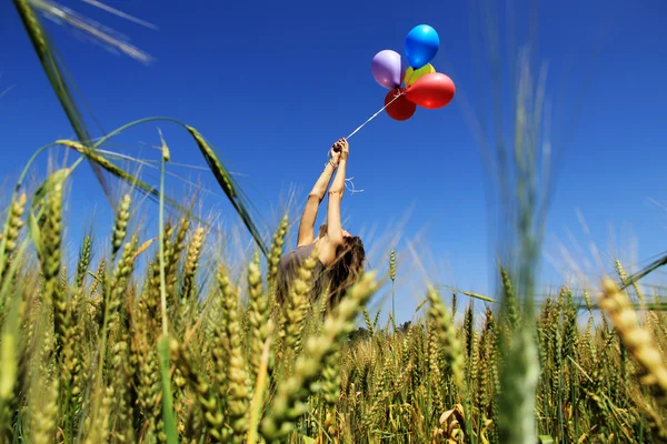 Young woman with colorful balloons. Photo in old image style. — Stock Photo, Image