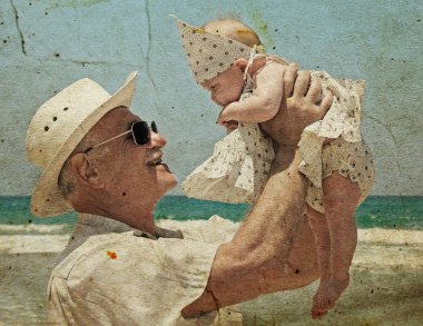 Happy grandpa is holding a little granddaughter. clipart